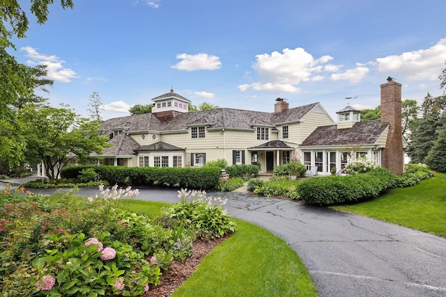 shingle-style home with a front yard