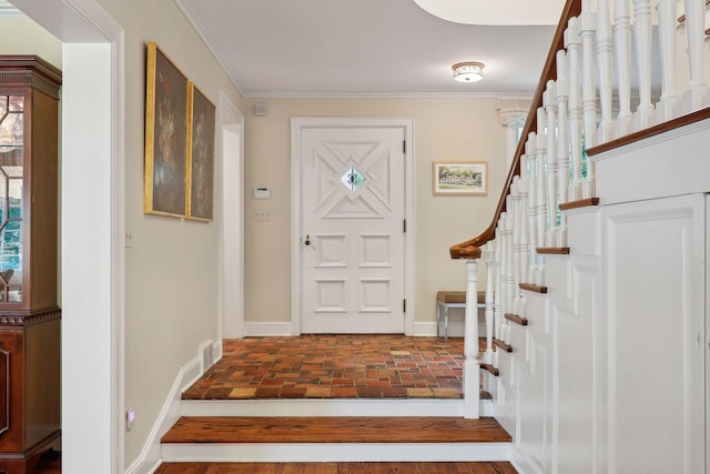 entryway with stairs, baseboards, brick floor, and ornamental molding