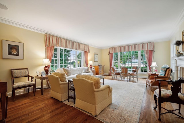 living area featuring a wealth of natural light, a fireplace, wood finished floors, and crown molding