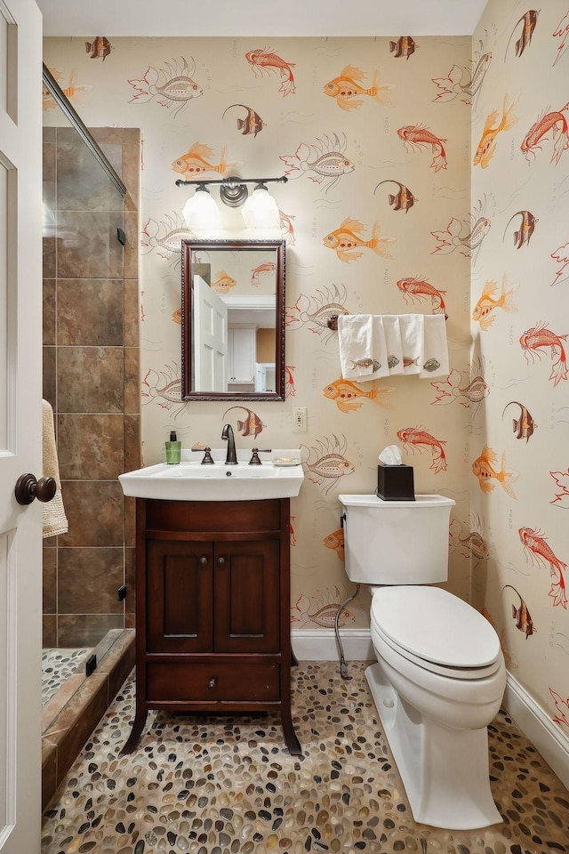 full bath featuring a shower stall, wallpapered walls, vanity, and toilet