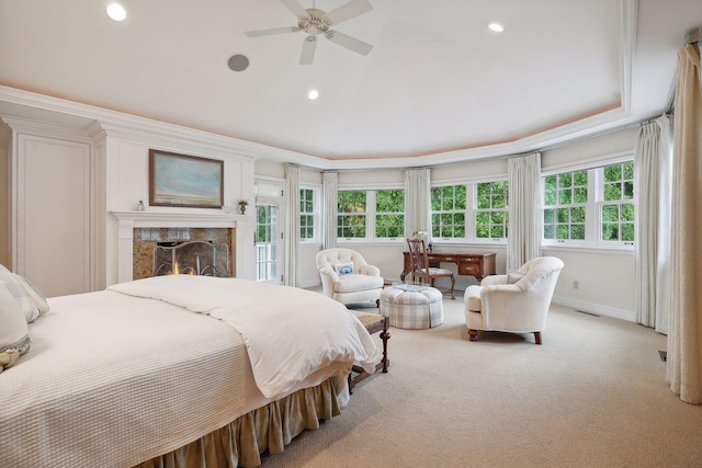 bedroom with visible vents, recessed lighting, a premium fireplace, baseboards, and light colored carpet