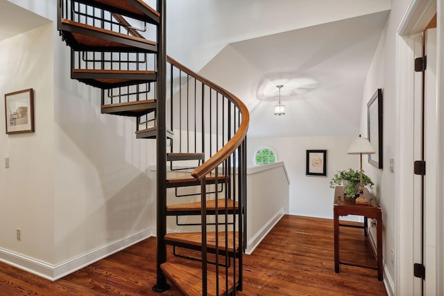 stairway featuring baseboards and wood finished floors