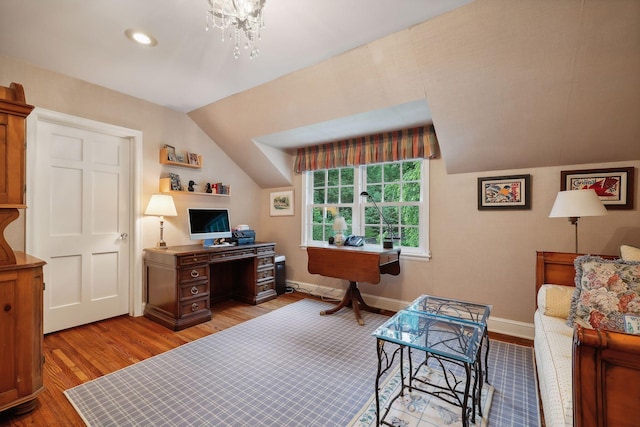 office featuring light wood-type flooring, baseboards, lofted ceiling, and a chandelier