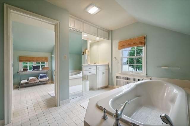 bathroom featuring vanity, radiator, a tub to relax in, lofted ceiling, and tile patterned floors