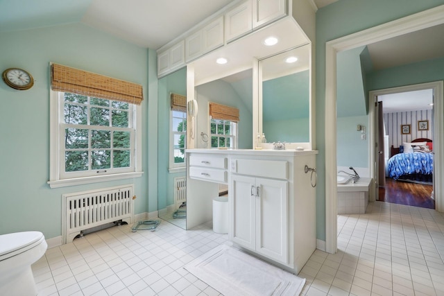 bathroom with tile patterned flooring, radiator, vanity, and vaulted ceiling