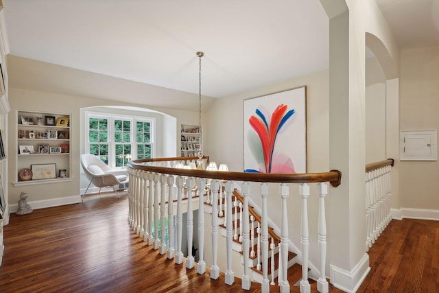 stairway with baseboards and wood finished floors