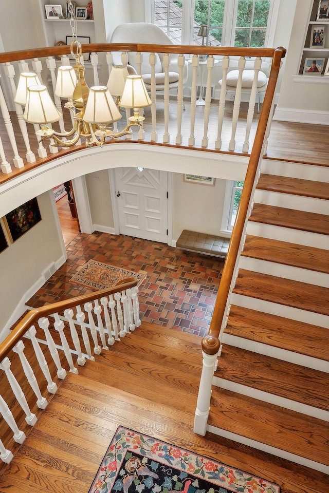 staircase featuring brick floor