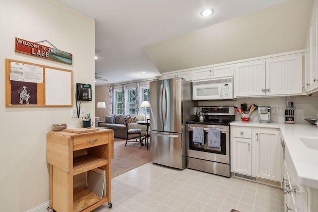 kitchen with visible vents, white cabinetry, recessed lighting, appliances with stainless steel finishes, and light countertops