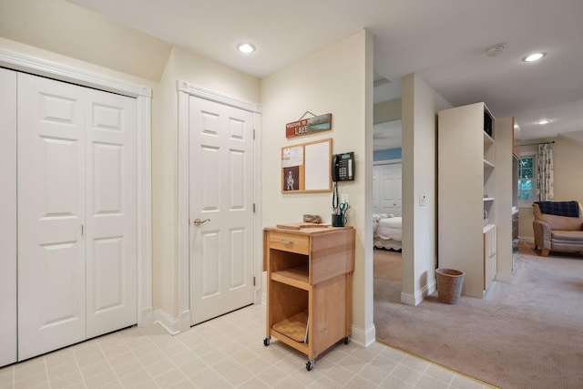 foyer featuring recessed lighting, baseboards, and light colored carpet