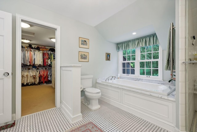 full bath featuring vaulted ceiling, a shower, a walk in closet, a garden tub, and toilet