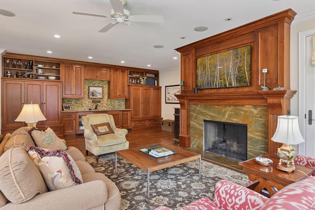 2670 Woolsey Ln, Woodland, MN 55391 - living area with dark wood-style floors, ceiling fan, a high end fireplace, recessed lighting, and crown molding