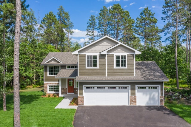 view of front of home with a garage and a front lawn