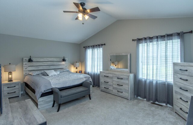 carpeted bedroom featuring ceiling fan and vaulted ceiling