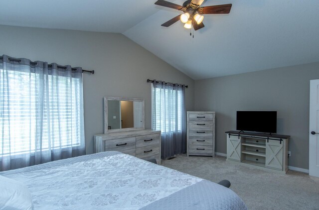 carpeted bedroom with vaulted ceiling and ceiling fan