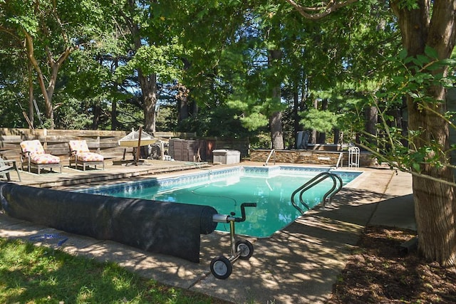 view of swimming pool featuring a patio area