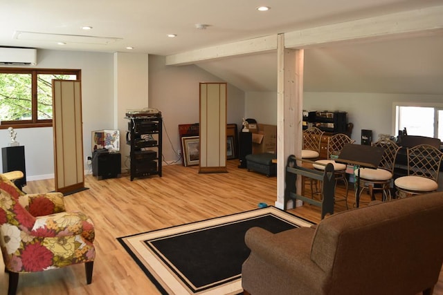 living room with light hardwood / wood-style flooring, a wall unit AC, and lofted ceiling with beams