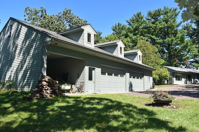 view of home's exterior featuring a lawn and a garage