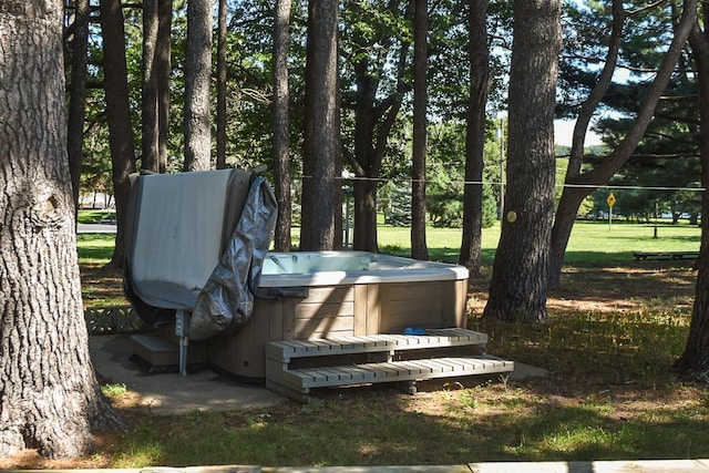 entry to storm shelter featuring a lawn and a hot tub