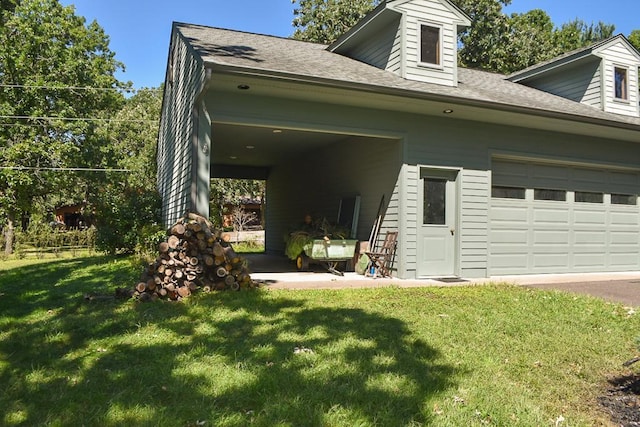 exterior space featuring a yard, a garage, and roof with shingles