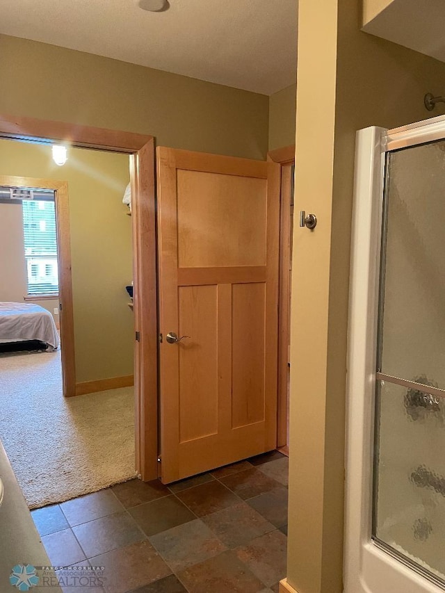 bathroom featuring a shower with door