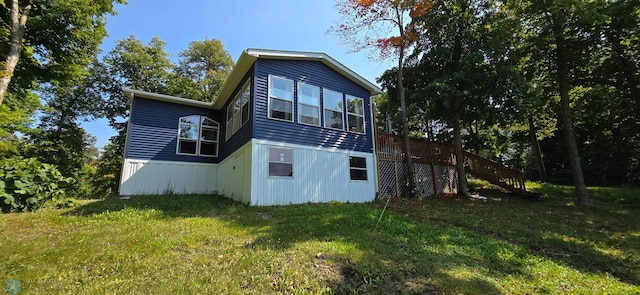 back of house with a lawn