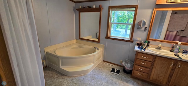 bathroom with vanity and a bath