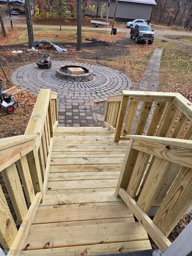 wooden terrace featuring an outdoor fire pit