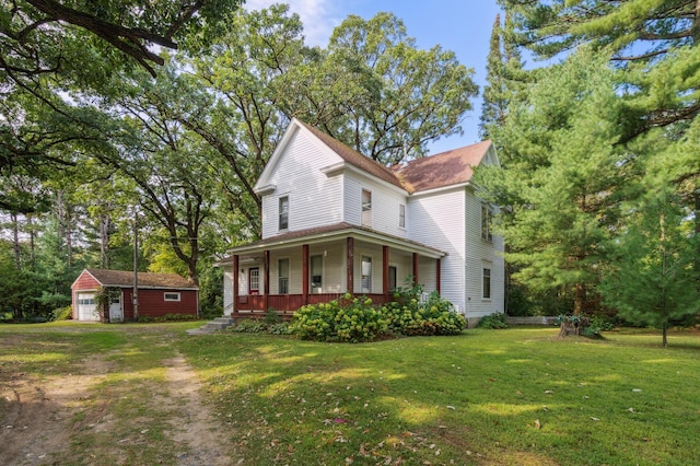 view of front of property featuring an outbuilding, a porch, and a front yard