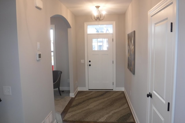 foyer entrance with a chandelier