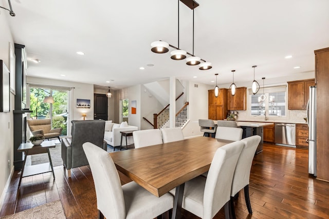 dining room with dark wood-type flooring, stairway, and recessed lighting