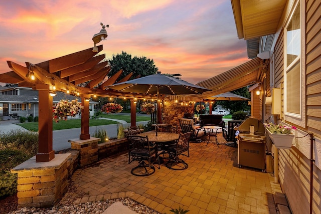 patio terrace at dusk with outdoor dining area and grilling area