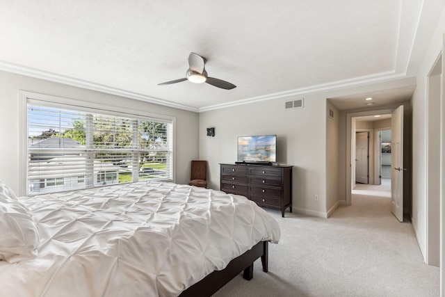 bedroom featuring light carpet, ornamental molding, and ceiling fan