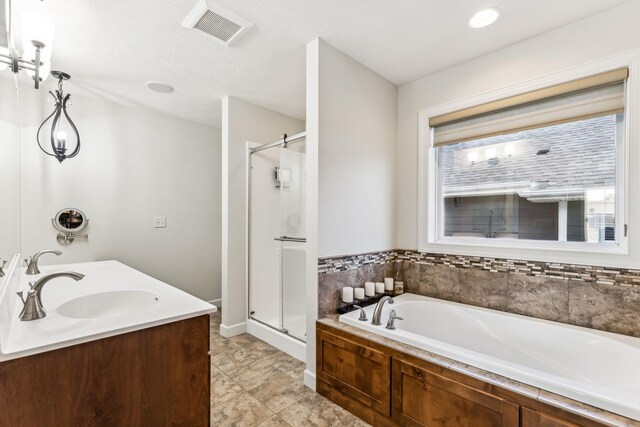 bathroom with separate shower and tub and vanity