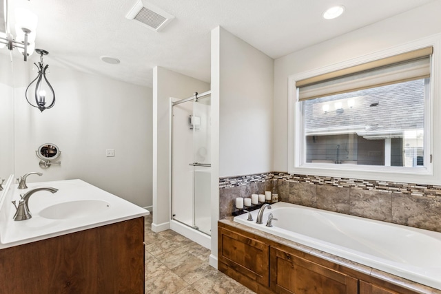 full bath with a garden tub, a sink, visible vents, and a shower stall