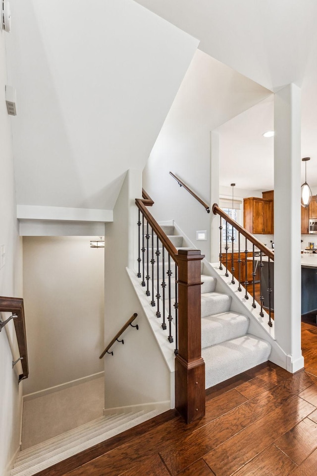 stairs featuring hardwood / wood-style floors