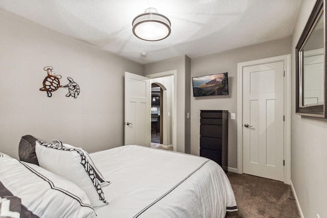 carpeted bedroom with a textured ceiling