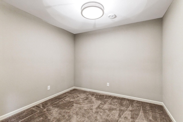 unfurnished room featuring carpet floors and baseboards