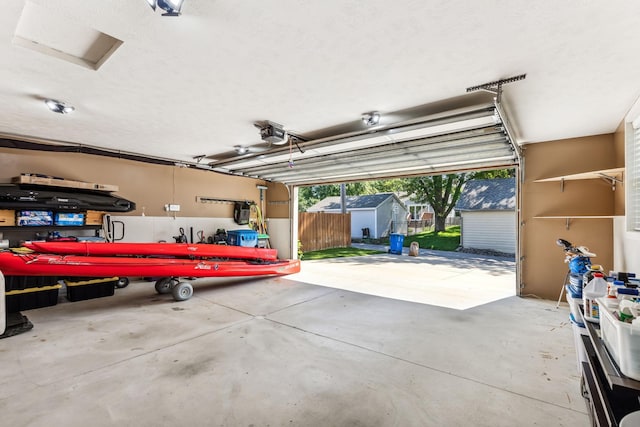 garage featuring a garage door opener and a storage unit