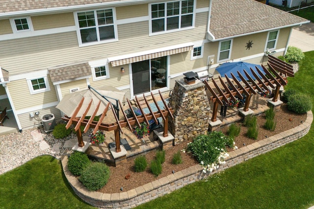 back of property featuring a patio area, a shingled roof, and central AC unit