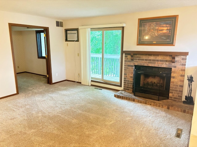 unfurnished living room with visible vents, a brick fireplace, baseboards, and carpet