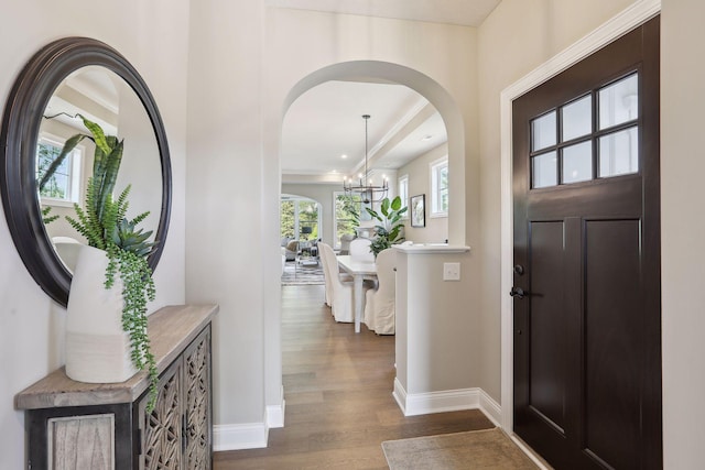 entrance foyer with wood-type flooring and an inviting chandelier