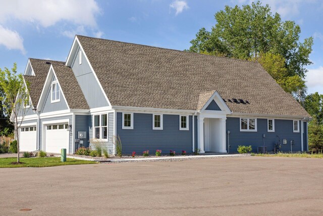 view of front of house featuring cooling unit and a garage