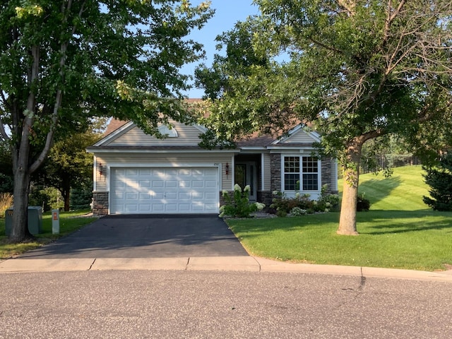 view of front of property featuring a garage and a front yard