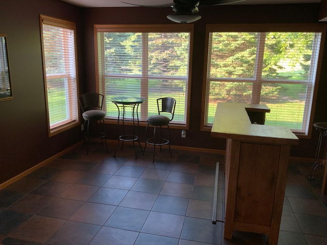 sunroom featuring ceiling fan