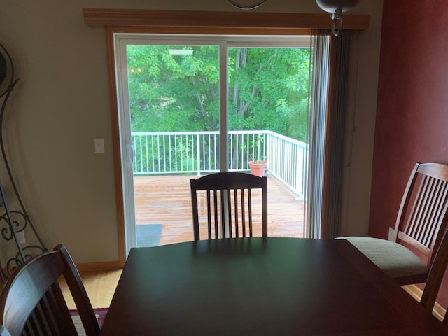 dining area with a healthy amount of sunlight and hardwood / wood-style floors