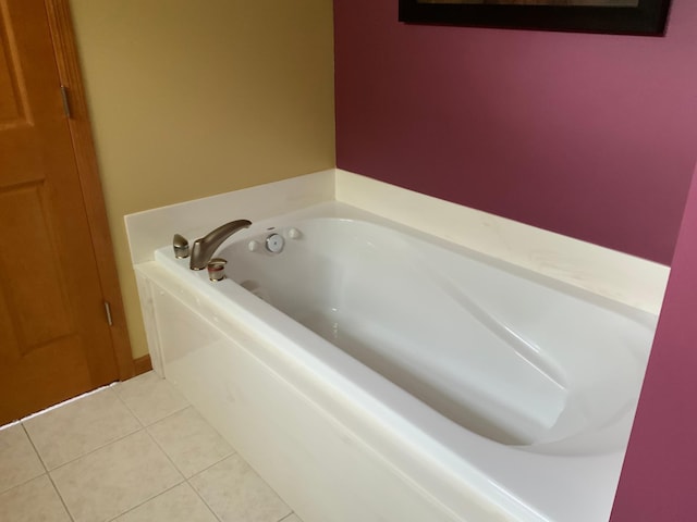 bathroom with a bathing tub and tile patterned flooring