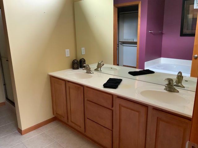 bathroom with tile patterned floors, vanity, and separate shower and tub