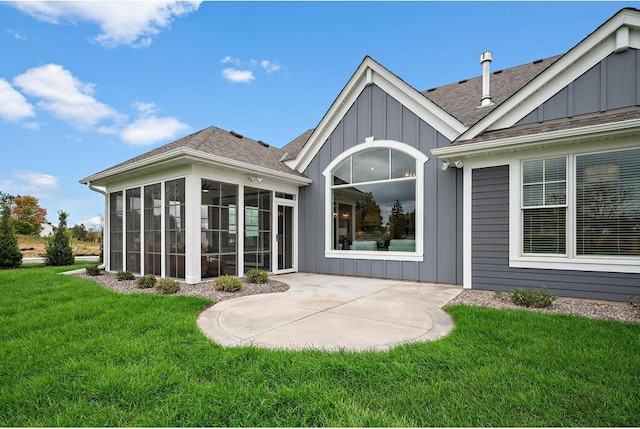 back of property featuring a lawn, a patio, and a sunroom