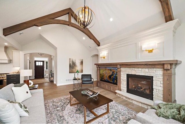 living room featuring high vaulted ceiling, beam ceiling, a fireplace, and dark wood-type flooring