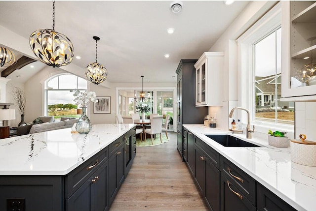 kitchen featuring white cabinets, sink, and a wealth of natural light